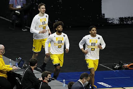 Mar 22, 2021; Indianapolis, Indiana, USA; Michigan Wolverines run onto the court before the game against the Louisiana State Tigers in the second round of the 2021 NCAA Tournament at Lucas Oil Stadium. Mandatory Credit: Joshua Bickel-USA TODAY Sports