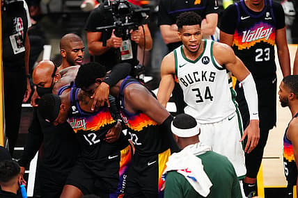 Jul 8, 2021; Phoenix, Arizona, USA; Milwaukee Bucks forward Giannis Antetokounmpo (34) checks on Phoenix Suns forward Torrey Craig (12) who sufferes an apparent injury during the second half in game two of the 2021 NBA Finals at Phoenix Suns Arena. Mandatory Credit: Mark J. Rebilas-USA TODAY Sports