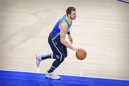Jan 8, 2020; Dallas, Texas, USA; Dallas Mavericks forward Luka Doncic (77) and the shadow outline of former player Dirk Nowitzki during the game between the Mavericks and the Nuggets at the American Airlines Center. Mandatory Credit: Jerome Miron-USA TODAY Sports