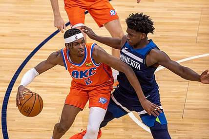 Mar 22, 2021; Minneapolis, Minnesota, USA; (Oklahoma City Thunder guard Shai Gilgeous-Alexander (2) dribbles the ball as Minnesota Timberwolves forward Anthony Edwards (1) plays defense in the second half at Target Center. Mandatory Credit: Jesse Johnson-USA TODAY Sports