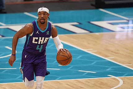 Apr 27, 2021; Charlotte, North Carolina, USA; Charlotte Hornets guard Devonte' Graham (4) brings the ball up court against the Milwaukee Bucks in the first half at Spectrum Center. The Milwaukee Bucks won 114-104. Mandatory Credit: Nell Redmond-USA TODAY Sports