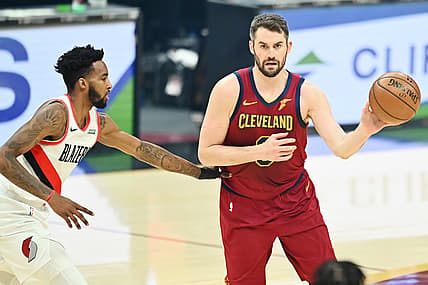 May 5, 2021; Cleveland, Ohio, USA; Portland Trail Blazers forward Derrick Jones Jr. (5) defends Cleveland Cavaliers forward Kevin Love (0) during the first quarter at Rocket Mortgage FieldHouse. Mandatory Credit: Ken Blaze-USA TODAY Sports