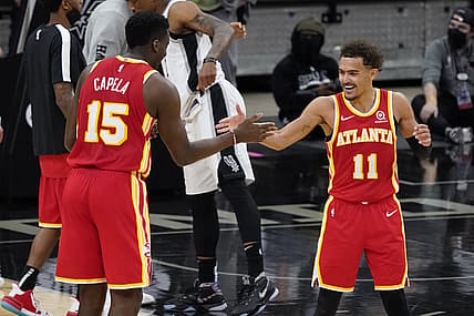Apr 1, 2021; San Antonio, Texas, USA; Atlanta Hawks center Clint Capela (15) and guard Trae Young (11) celebrate after their double overtime victory over the San Antonio Spurs at AT&T Center. Mandatory Credit: Scott Wachter-USA TODAY Sports