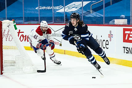 Feb 27, 2021; Winnipeg, Manitoba, CAN;   Winnipeg Jets defenseman Sami Niku (8) skates away from Montreal Canadiens forward Paul Byron (41) during the first period at Bell MTS Place. Mandatory Credit: Terrence Lee-USA TODAY Sports
