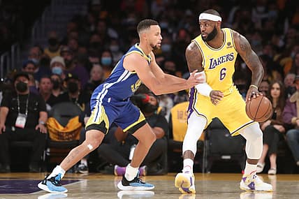 Oct 19, 2021; Los Angeles, California, USA; Los Angeles Lakers forward LeBron James (6) dribbles a ball against Golden State Warriors guard Stephen Curry (30) during the first quarter at Staples Center. Mandatory Credit: Kiyoshi Mio-USA TODAY Sports