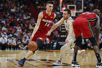 Oct 21, 2021; Miami, Florida, USA; Miami Heat guard Tyler Herro (14) dribbles the ball around Milwaukee Bucks guard Pat Connaughton (24) during the fourth quarter of the game at FTX Arena. Mandatory Credit: Sam Navarro-USA TODAY Sports