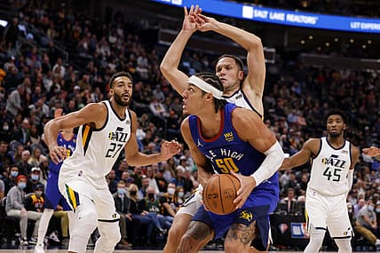Oct 26, 2021; Salt Lake City, Utah, USA;  Denver Nuggets forward Aaron Gordon (50)  looks to shoot against Utah Jazz center Rudy Gobert (27) and forward Bojan Bogdanovic (44) during the first quarter at Vivint Arena. Mandatory Credit: Chris Nicoll-USA TODAY Sports