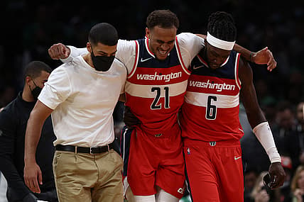 Oct 27, 2021; Boston, Massachusetts, USA; Washington Wizards center Daniel Gafford (21) is helped off the court after being injured against the Boston Celtics during the second quarter at TD Garden. Mandatory Credit: Winslow Townson-USA TODAY Sports