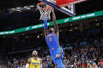 Oct 27, 2021; Oklahoma City, Oklahoma, USA; Oklahoma City Thunder forward Luguentz Dort (5) dunks over Los Angeles Lakers forward Carmelo Anthony (7) during the second half at Paycom Center. Oklahoma City won 123-115. Mandatory Credit: Alonzo Adams-USA TODAY Sports