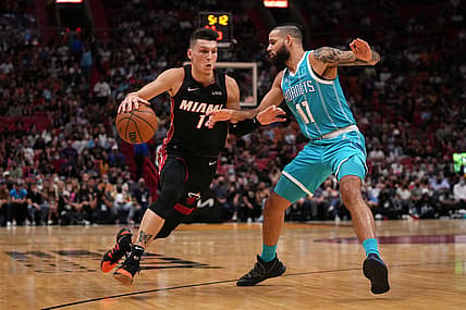 Oct 29, 2021; Miami, Florida, USA; Miami Heat guard Tyler Herro (14) drives the ball around Charlotte Hornets forward Cody Martin (11) during the first half at FTX Arena. Mandatory Credit: Jasen Vinlove-USA TODAY Sports