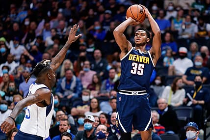 Oct 29, 2021; Denver, Colorado, USA; Denver Nuggets guard P.J. Dozier (35) attempts a shot as Dallas Mavericks forward Reggie Bullock (25) defends in the second quarter at Ball Arena. Mandatory Credit: Isaiah J. Downing-USA TODAY Sports
