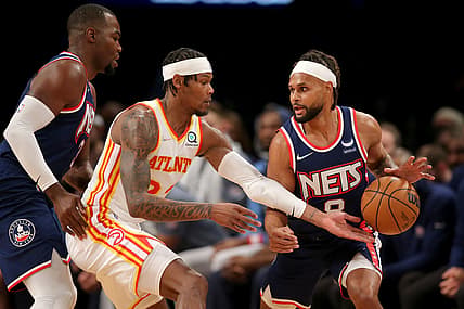 Nov 3, 2021; Brooklyn, New York, USA; Atlanta Hawks forward Cam Reddish (22) reaches for a ball controlled by Brooklyn Nets guard Patty Mills (8) in front of Nets forward Paul Millsap (31) during the second quarter at Barclays Center. Mandatory Credit: Brad Penner-USA TODAY Sports
