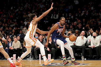 Nov 3, 2021; Brooklyn, New York, USA; Brooklyn Nets forward Kevin Durant (7) controls the ball against Atlanta Hawks forward De'Andre Hunter (12) during the fourth quarter at Barclays Center. Mandatory Credit: Brad Penner-USA TODAY Sports