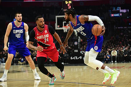 Nov 9, 2021; Los Angeles, California, USA; Los Angeles Clippers guard Paul George (13) moves the ball against Portland Trail Blazers forward Norman Powell (24) during the first half at Staples Center. Mandatory Credit: Gary A. Vasquez-USA TODAY Sports