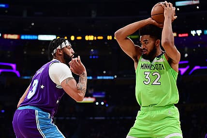 Nov 12, 2021; Los Angeles, California, USA; Minnesota Timberwolves center Karl-Anthony Towns (32) controls the ball against Los Angeles Lakers forward Anthony Davis (3) during the first half at Staples Center. Mandatory Credit: Gary A. Vasquez-USA TODAY Sports