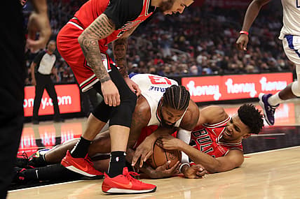 Nov 14, 2021; Los Angeles, California, USA; Los Angeles Clippers forward Paul George (13) and Chicago Bulls center Tony Bradley (13) fights for a ball during the first quarter at Staples Center. Mandatory Credit: Kiyoshi Mio-USA TODAY Sports