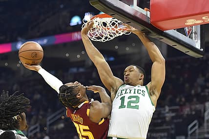 Nov 15, 2021; Cleveland, Ohio, USA; Boston Celtics forward Grant Williams (12) defends a shot by Cleveland Cavaliers forward Isaac Okoro (35) in the second quarter at Rocket Mortgage FieldHouse. Mandatory Credit: David Richard-USA TODAY Sports