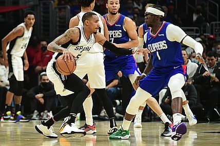 Nov 16, 2021; Los Angeles, California, USA; San Antonio Spurs guard Dejounte Murray (5) moves the ball against Los Angeles Clippers guard Reggie Jackson (1) during the first half at Staples Center. Mandatory Credit: Gary A. Vasquez-USA TODAY Sports