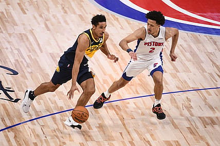 Nov 17, 2021; Detroit, Michigan, USA; Indiana Pacers guard Malcolm Brogdon (7) drives to the basket as Detroit Pistons guard Cade Cunningham (2) defends during the second quarter at Little Caesars Arena. Mandatory Credit: Tim Fuller-USA TODAY Sports