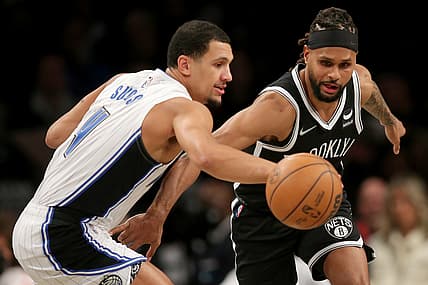 Nov 19, 2021; Brooklyn, New York, USA; Orlando Magic guard Jalen Suggs (4) steals the ball from Brooklyn Nets guard Patty Mills (8) during the first quarter at Barclays Center. Mandatory Credit: Brad Penner-USA TODAY Sports