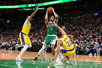 Nov 19, 2021; Boston, Massachusetts, USA; Boston Celtics forward Jayson Tatum (0) drives to the basket defended by Los Angeles Lakers guard Avery Bradley (20) and Los Angeles Lakers forward Anthony Davis (3) during the first half at TD Garden. Mandatory Credit: Paul Rutherford-USA TODAY Sports