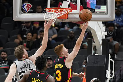 Nov 24, 2021; San Antonio, Texas, USA; Atlanta Hawks guard Kevin Huerter (3) drives to the basket past San Antonio Spurs center Jakob Poeltl (25) during the first half at AT&T Center. Mandatory Credit: Scott Wachter-USA TODAY Sports