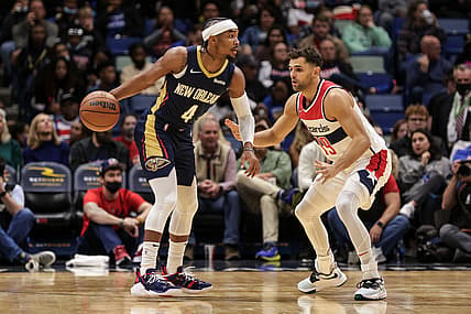 Nov 24, 2021; New Orleans, Louisiana, USA;  New Orleans Pelicans guard Devonte' Graham (4) looks to pass the ball against Washington Wizards guard Raul Neto (19) during the first half at Smoothie King Center. Mandatory Credit: Stephen Lew-USA TODAY Sports