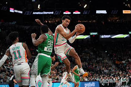 Nov 26, 2021; San Antonio, Texas, USA;  San Antonio Spurs forward Keldon Johnson (3) rebounds in the first half against the Boston Celtics at the AT&T Center. Mandatory Credit: Daniel Dunn-USA TODAY Sports