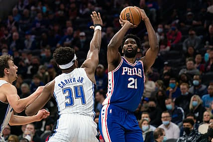 Nov 29, 2021; Philadelphia, Pennsylvania, USA; Philadelphia 76ers center Joel Embiid (21) shoots in front of Orlando Magic center Wendell Carter Jr. (34) during the second quarter at Wells Fargo Center. Mandatory Credit: Bill Streicher-USA TODAY Sports