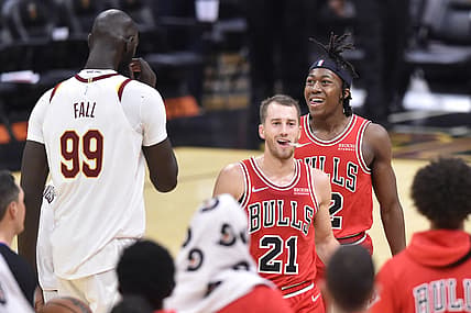 Oct 10, 2021; Cleveland, Ohio, USA; Chicago Bulls guard Ayo Dosunmu (12) celebrates his basket beside guard Matt Thomas (21) and Cleveland Cavaliers center Tacko Fall (99) in the fourth quarter at Rocket Mortgage FieldHouse. Mandatory Credit: David Richard-USA TODAY Sports