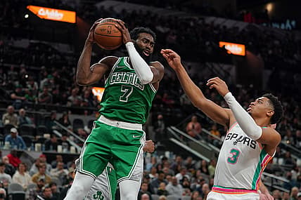 Nov 26, 2021; San Antonio, Texas, USA;  Boston Celtics guard Jaylen Brown (7) rebounds in front of San Antonio Spurs forward Keldon Johnson (3) in the second half at the AT&T Center. Mandatory Credit: Daniel Dunn-USA TODAY Sports