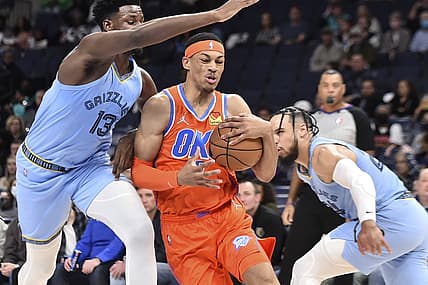 Dec 2, 2021; Memphis, Tennessee, USA; Oklahoma City Thunder forward Darius Bazley (7) goes to the basket against Memphis Grizzlies forward Jaren Jackson Jr. (13) during the first half  at FedExForum. Mandatory Credit: Justin Ford-USA TODAY Sports