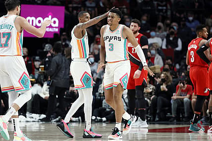 Dec 2, 2021; Portland, Oregon, USA; cSan Antonio Spurs small forward Keldon Johnson (3) celebrates a basket and a foul with teammate Dejounte Murray (5) during the first half against the Portland Trail Blazers at Moda Center. Mandatory Credit: Soobum Im-USA TODAY Sports