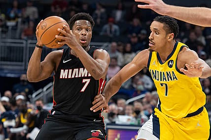 Dec 3, 2021; Indianapolis, Indiana, USA; Miami Heat guard Kyle Lowry (7) passes the ball while Indiana Pacers guard Malcolm Brogdon (7) defends  in the first half at Gainbridge Fieldhouse. Mandatory Credit: Trevor Ruszkowski-USA TODAY Sports