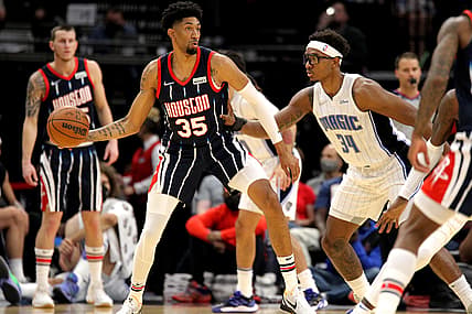 Dec 3, 2021; Houston, Texas, USA; Houston Rockets center Christian Wood (35) handles the ball while Orlando Magic center Wendell Carter Jr. (34) defends during the first quarter at Toyota Center. Mandatory Credit: Erik Williams-USA TODAY Sports