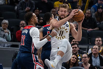 Dec 6, 2021; Indianapolis, Indiana, USA; Indiana Pacers forward Domantas Sabonis (11) rebounds the ball over Washington Wizards center Daniel Gafford (21) in the first quarter at Gainbridge Fieldhouse. Mandatory Credit: Trevor Ruszkowski-USA TODAY Sports