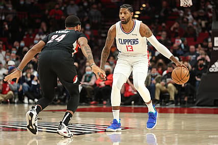 Dec 6, 2021; Portland, Oregon, USA;  LA Clippers guard Paul George (13) brings the ball up-court against Portland Trail Blazers forward Norman Powell (24) in the first half at Moda Center. Mandatory Credit: Jaime Valdez-USA TODAY Sports