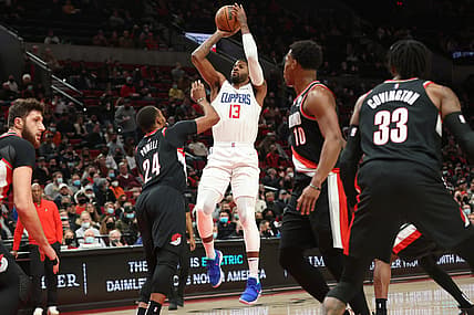 Dec 6, 2021; Portland, Oregon, USA;  LA Clippers guard Paul George (13) shoots over Portland Trail Blazers forward Norman Powell (24) in the first half at Moda Center. Mandatory Credit: Jaime Valdez-USA TODAY Sports