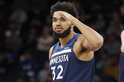 Dec 6, 2021; Minneapolis, Minnesota, USA; Minnesota Timberwolves center Karl-Anthony Towns (32) sends a salute towards the Atlanta Hawks bench as the game is about to start at Target Center. Mandatory Credit: Bruce Kluckhohn-USA TODAY Sports