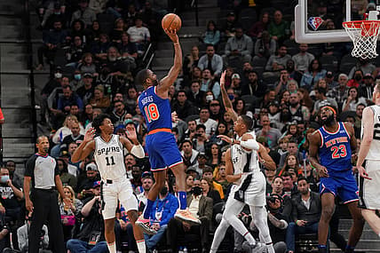Dec 7, 2021; San Antonio, Texas, USA;  New York Knicks guard Alec Burks (18) shoots over San Antonio Spurs guard Dejounte Murray (5) in the first half at the AT&T Center. Mandatory Credit: Daniel Dunn-USA TODAY Sports