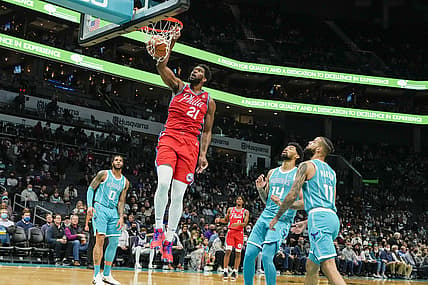 Dec 8, 2021; Charlotte, North Carolina, USA;  Philadelphia 76ers center Joel Embiid (21) gets a dunk on Charlotte Hornets forward Cody Martin (11) during the first quarter at the Spectrum Center. Mandatory Credit: Jim Dedmon-USA TODAY Sports