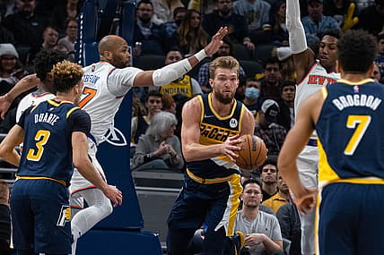Dec 8, 2021; Indianapolis, Indiana, USA; Indiana Pacers forward Domantas Sabonis (11) passes the ball while New York Knicks center Taj Gibson (67) defends in the first half at Gainbridge Fieldhouse. Mandatory Credit: Trevor Ruszkowski-USA TODAY Sports