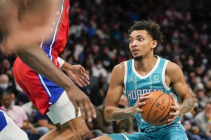Dec 8, 2021; Charlotte, North Carolina, USA; Charlotte Hornets guard James Bouknight (5) runs into Philadelphia 76ers center Joel Embiid (21) on his way to the basket during the second half at the Spectrum Center. Mandatory Credit: Jim Dedmon-USA TODAY Sports