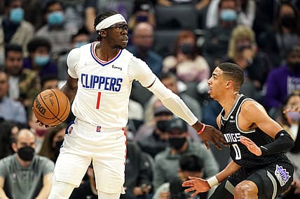 Dec 4, 2021; Sacramento, California, USA; LA Clippers guard Reggie Jackson (1) handles the ball while being defended by Sacramento Kings guard Tyrese Haliburton (0) during the second quarter at Golden 1 Center. Mandatory Credit: Darren Yamashita-USA TODAY Sports