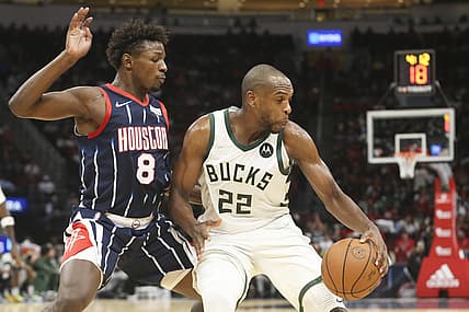 Dec 10, 2021; Houston, Texas, USA; Milwaukee Bucks forward Khris Middleton (22) dribbles against Houston Rockets forward Jae'Sean Tate (8) in the second quarter at Toyota Center. Mandatory Credit: Thomas Shea-USA TODAY Sports