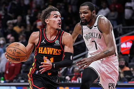 Dec 10, 2021; Atlanta, Georgia, USA; Atlanta Hawks guard Trae Young (11) tries to get to the basket guarded by Brooklyn Nets forward Kevin Durant (7) during the second half at State Farm Arena. Mandatory Credit: Dale Zanine-USA TODAY Sports