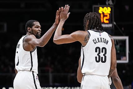 Dec 10, 2021; Atlanta, Georgia, USA; Brooklyn Nets forward Kevin Durant (7) reacts with forward Nic Claxton (33) after an altercation with Atlanta Hawks guard Trae Young (11) (not shown) during the second half at State Farm Arena. Mandatory Credit: Dale Zanine-USA TODAY Sports