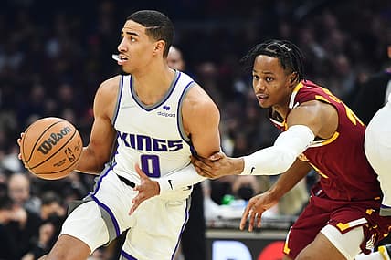 Dec 11, 2021; Cleveland, Ohio, USA; Sacramento Kings guard Tyrese Haliburton (0) controls the ball as Cleveland Cavaliers guard Isaac Okoro (35) defends during the first quarter at Rocket Mortgage FieldHouse. Mandatory Credit: Ken Blaze-USA TODAY Sports