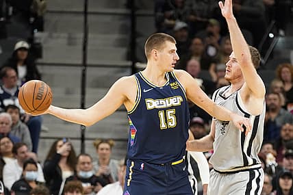 Dec 11, 2021; San Antonio, Texas, USA; Denver Nuggets center Nikola Jokic (15) looks to pass the ball while defended by San Antonio Spurs center Jakob Poeltl (25) during the first half at AT&T Center. Mandatory Credit: Scott Wachter-USA TODAY Sports