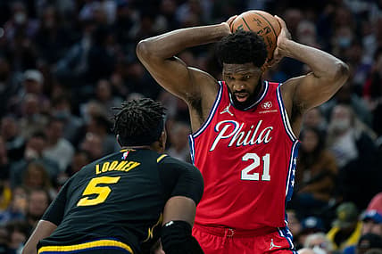 Dec 11, 2021; Philadelphia, Pennsylvania, USA; Philadelphia 76ers center Joel Embiid (21) controls the ball against Golden State Warriors center Kevon Looney (5) during the third quarter at Wells Fargo Center. Mandatory Credit: Bill Streicher-USA TODAY Sports